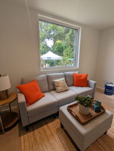 view of living room of unit with couch, end table, rug, and ottoman